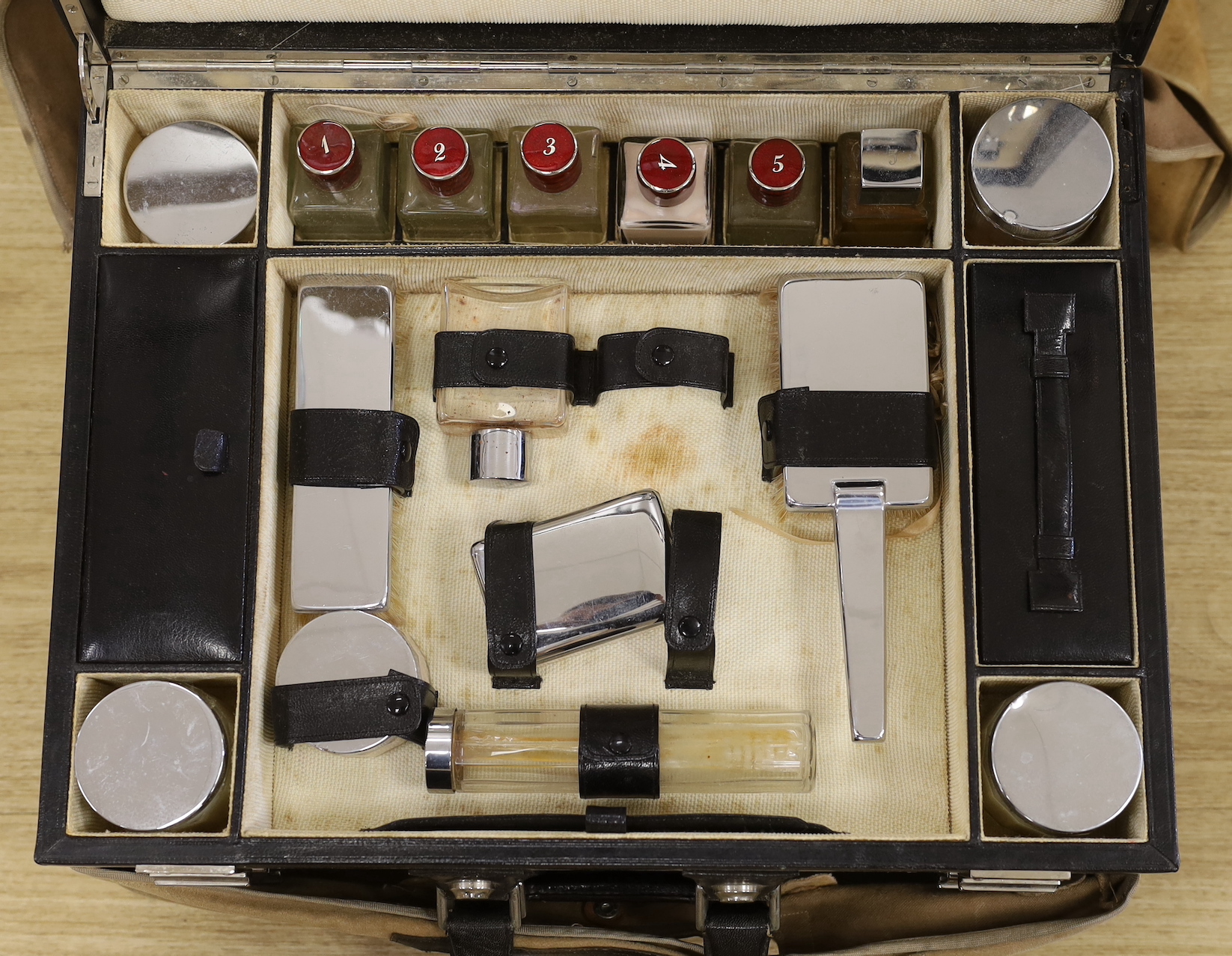 A stylish twin compartment vanity case and cover, with chrome plated accessories